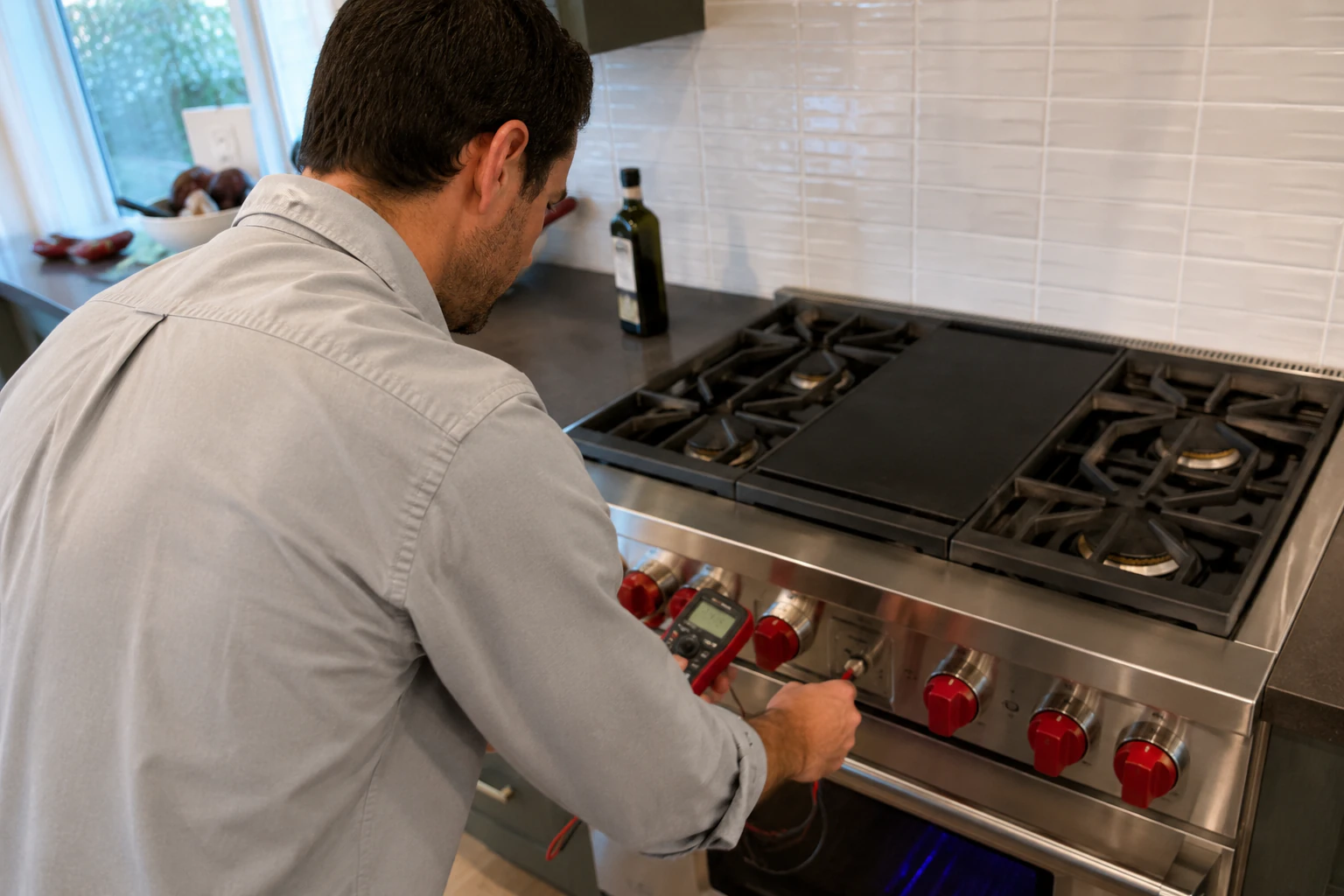 A technician servicing a warming drawer heating element on a Wolf appliance