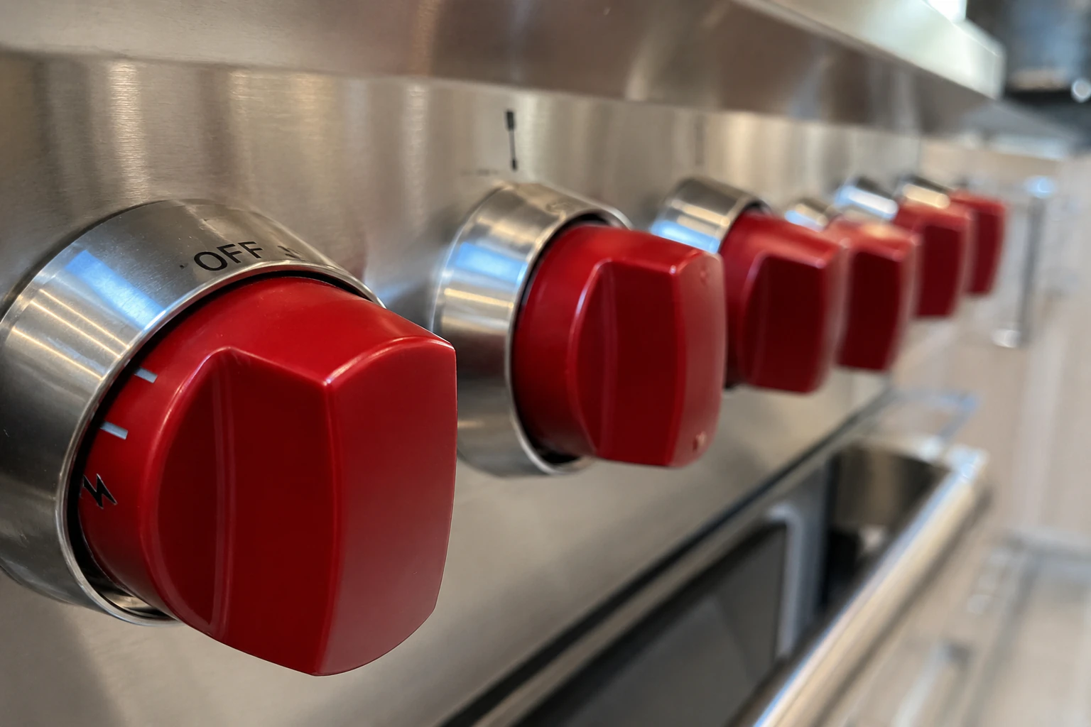 Close-up of a Wolf range burner grate and control panel